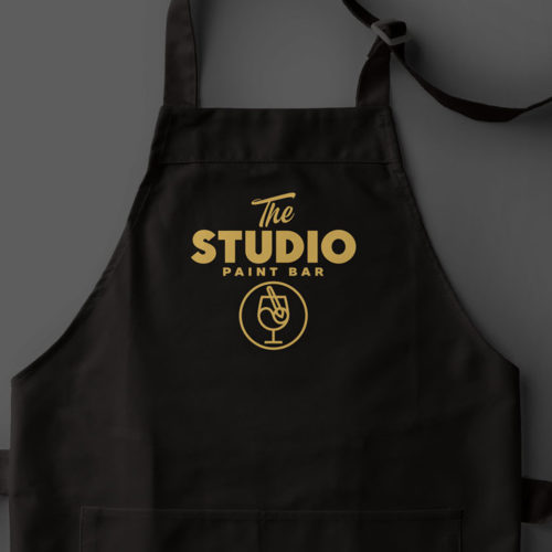 The Studio Paint Bar logo on apron